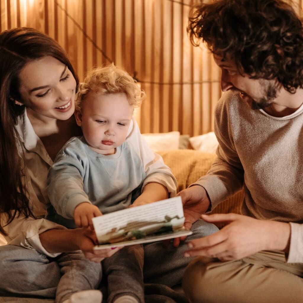 Parent helping child with speech therapy exercises at home using flashcards and playful interaction