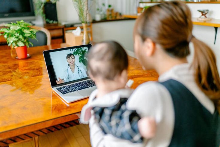 Parent working with toddler during a speech therapy session at home.