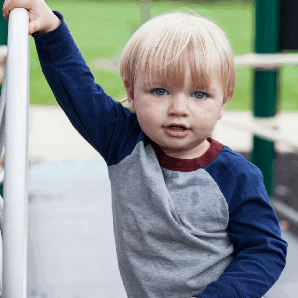 2-year-old child showing early signs of speech delay with concerned parent nearby
