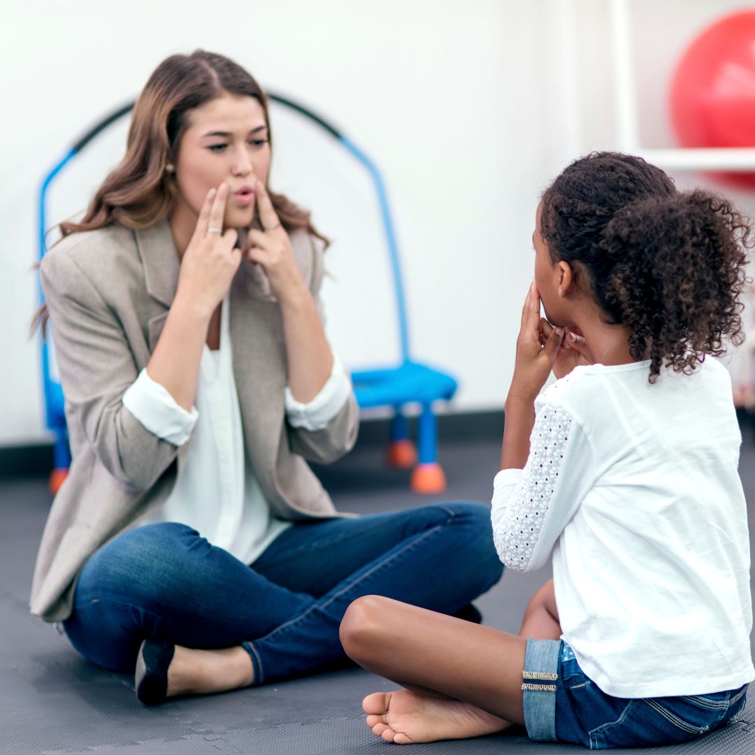 Parent talking to toddler while reading a book together, supporting speech development